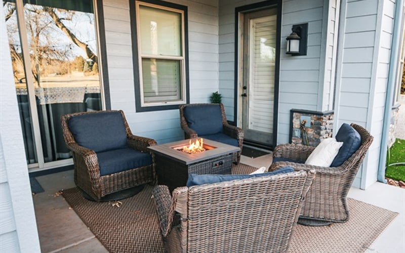 cozy firepit with swivel rockers on the back patio