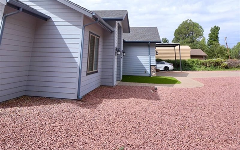 front entrance with driveway and covered parking