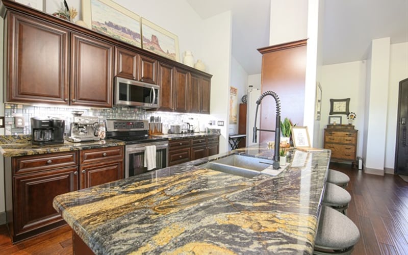 Enjoy open seating at the kitchen peninsula with barstools for 4 and connected to the open living room space