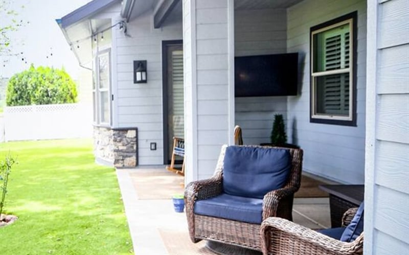 patio space with swivel rockers, rocking chairs, and fire pit, with direct view of Payson Golf Course